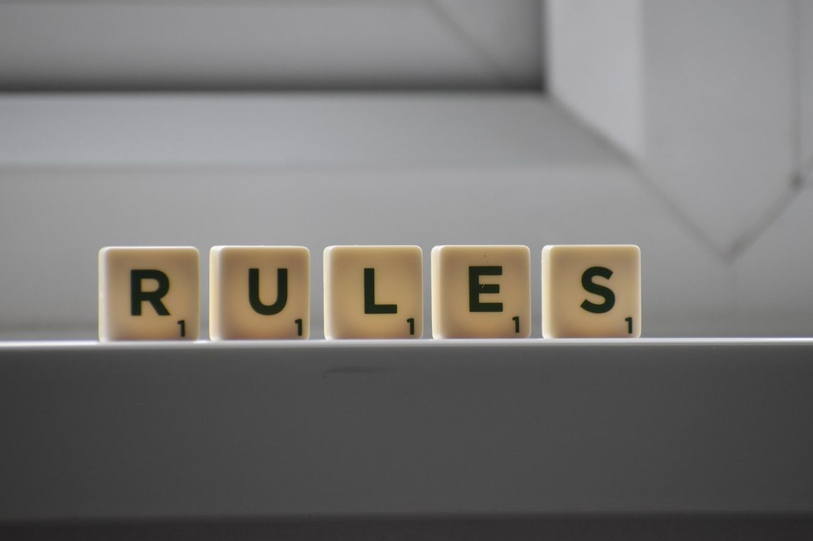 scrabble tiles spelling 'rules'