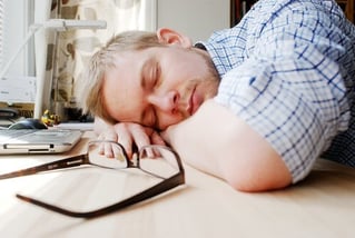 man sleeping at desk